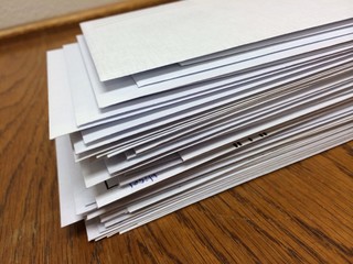 a stack of white envelopes at work ready to mail