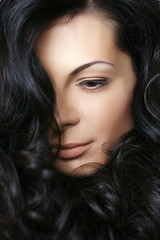 Fototapeta premium Brunette Woman with long curly hairs