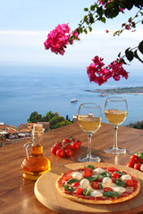 Fototapety  Sicily with pizza and white wine, Taormina, Italy