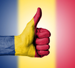 Closeup of male hand showing thumbs up sign