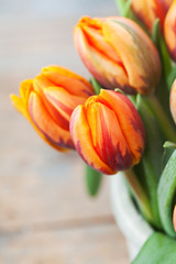 Bunch of beautiful orange tulips on wooden background