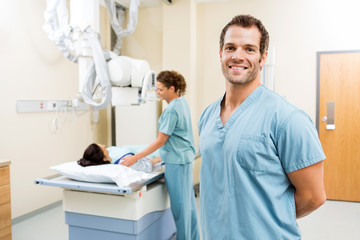 Nurse With Colleague Preparing Patient For Xray