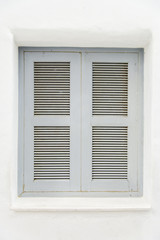 Gray wooden window on white wall