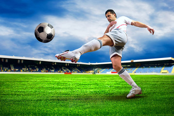 Happiness football player after goal on the field of stadium wit