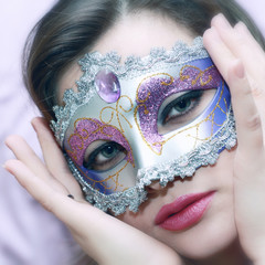 face of a beautiful girl in a brilliant festive mask