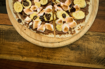 Dessert pizza with chocolate banana and marshmallow.