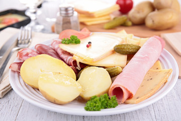 plate with cheese, ham, potato