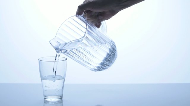 glass of water being filled by a pitcher