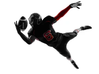 Fotobehang american football player catching ball  silhouette © snaptitude