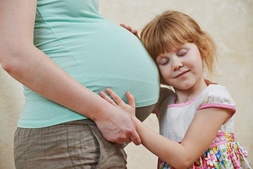 Pregnant woman belly and girl
