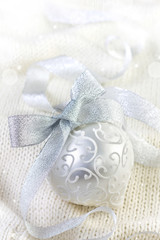 Fototapeta na wymiar Christmas ball on knit background
