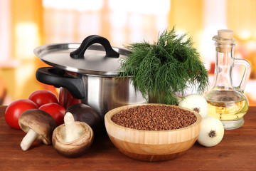 Ingredients for cooking buckwheat on table in kitchen