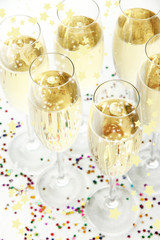 Glasses with champagne on shiny background