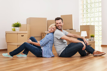 Loving couple sitting in their new apartment