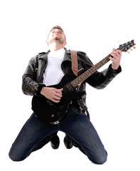 Obraz premium Young musician playing guitar, isolated on white