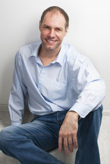 Portrait of smiling man sitting on the floor