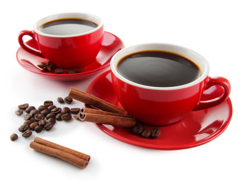 Red cups of strong coffee and coffee beans isolated on white