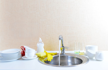 Dishes drying near  metal sink