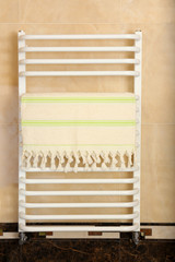 Fototapeta na wymiar Color towel on radiator in bathroom