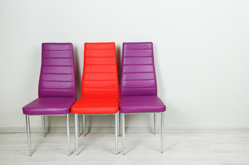 Modern  color chairs on wall background