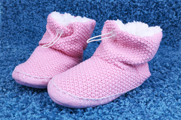 Warm winter home shoes on color background