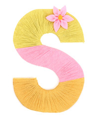 Letter S created with brightly colored knitting yard isolated