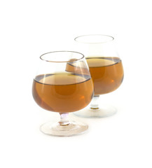 Two glasses with amber wine isolated on white close up