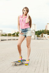 Pretty young woman and skateboard