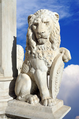 statue of lion on a background of blue sky