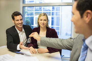 Real-estate agent giving keys to new property owners