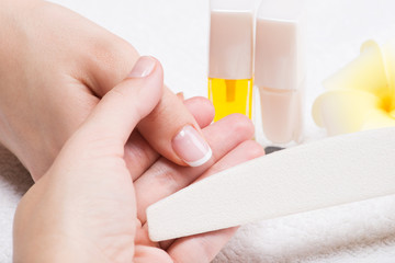 Woman in a nail salon receiving manicure