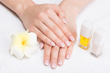 Woman in a nail salon receiving manicure