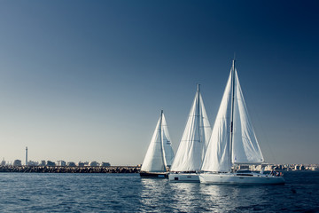 Sailing ship yachts with white sails