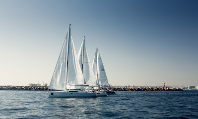 Sailing ship yachts with white sails