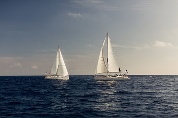 Sailing ship yachts with white sails