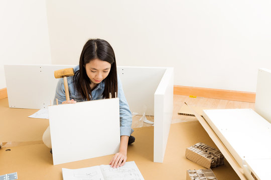 Asian Woman Assembling Closet