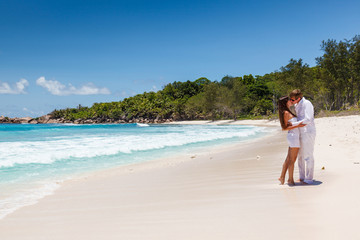 Young couple married laying on sandy beach