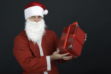 Santa Claus with Christmas Gift Box isolated on Black Background