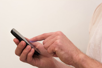 Young man using spartphone for networking on white background