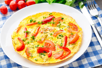 Omelet with paprika, tomato and herbs