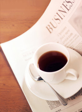 newspaper and coffee cup