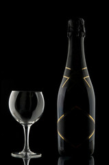 Champagne bottle and wineglass on black background