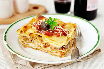 Rustic style lasagna with pork, mushrooms and lentils