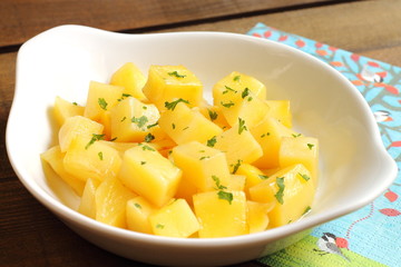 Steamed potato cubes with parsley and olive oil