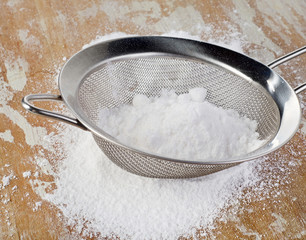 Powdered sugar in a metal sieve