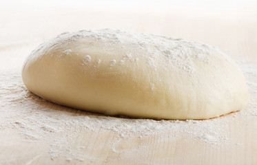 Fototapeta na wymiar Dough on wooden table.