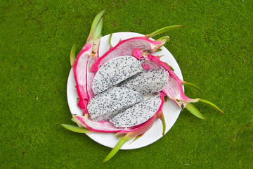 dragon fruits on green background.