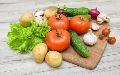 vegetables on a cutting board on a wooden table