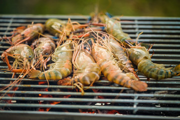 delicious prawn spit on grill with flames