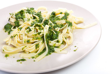 Tagliatelle with spinach on plate